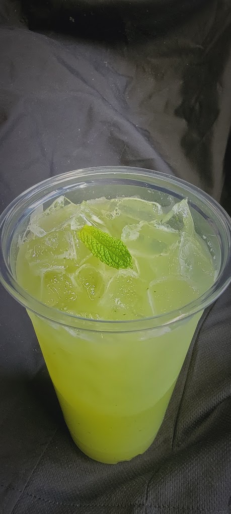 Iced cucumber lime agua fresca garnished with a mint leaf